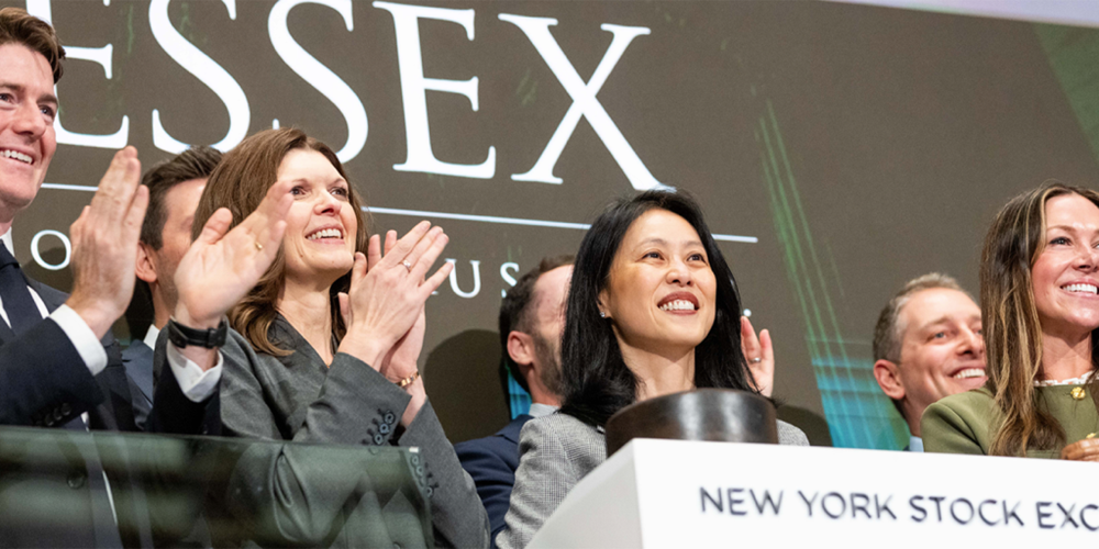 Essex Property Trust CEO and senior leaders standing together and smiling at the New York Stock Exchange.