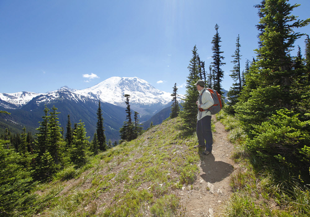 Young man hiking mount Rainier in Seattle, Washington. 