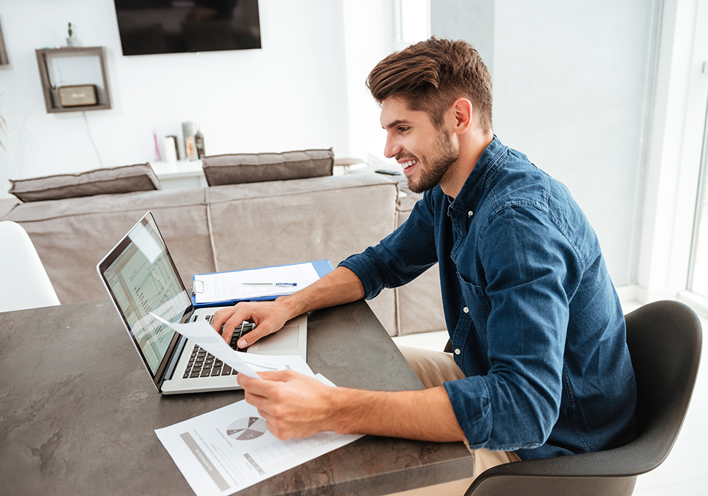 Man reviewing energy bill and paying online