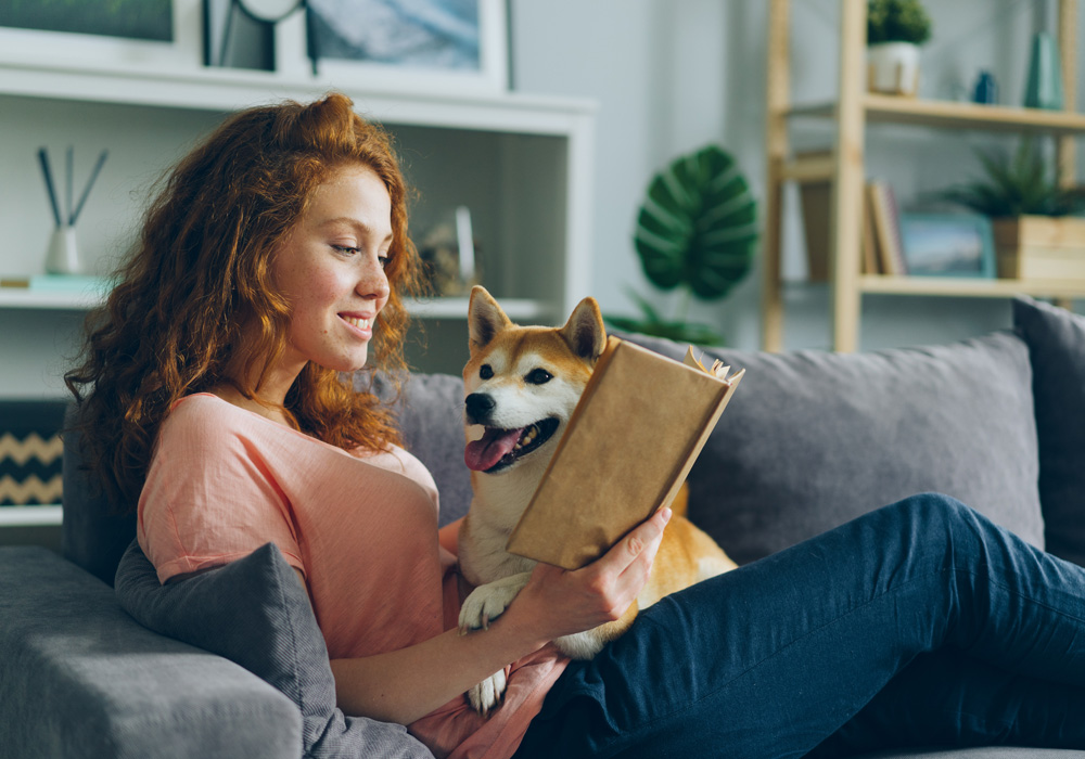 Relax and unplug at home with a good book and your best friend