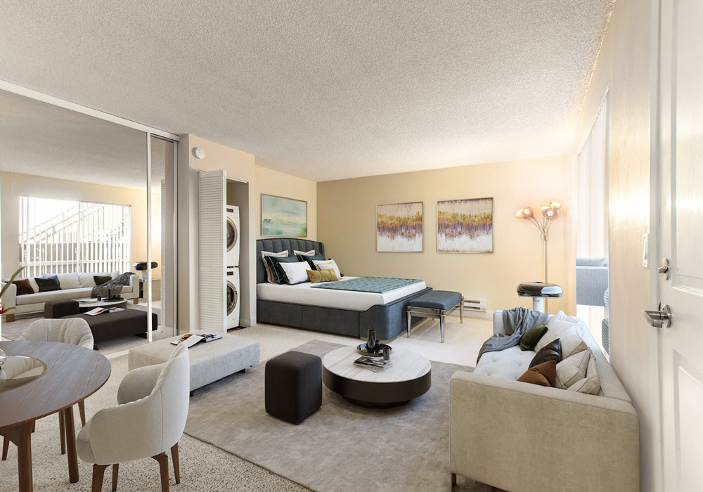 The Montclaire's staged studio apartment featuring bed, sofa, dining area, and laundry unit.