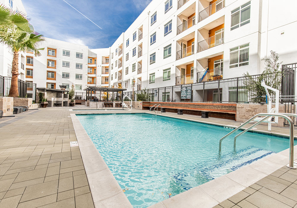 Outdoor swimming pool encircled by Patina at Midtown apartments.