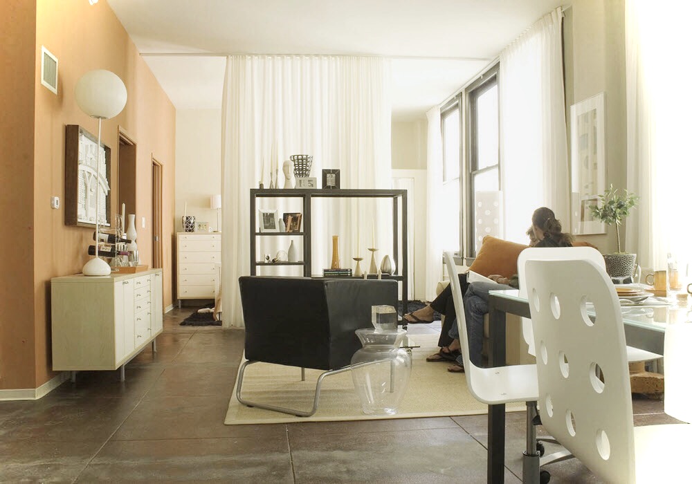 Staged Pacific Electric Lofts studio featuring orange accent wall.