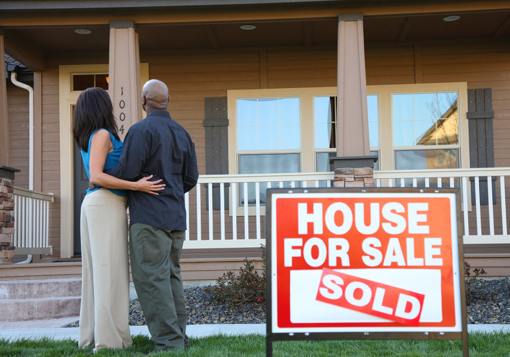 Couple selling their house to downsize to an apartment.