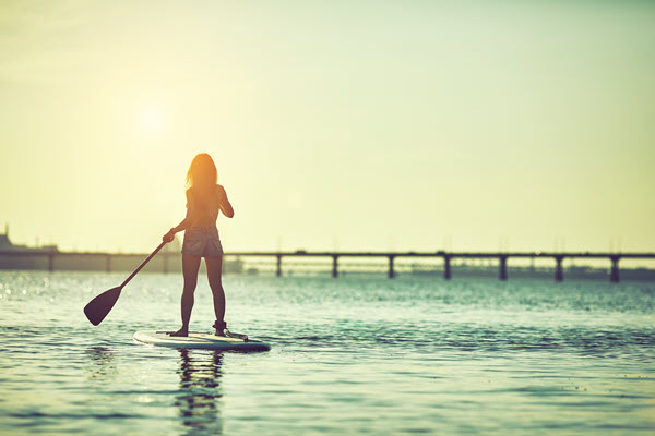 Woman paddleboarding.