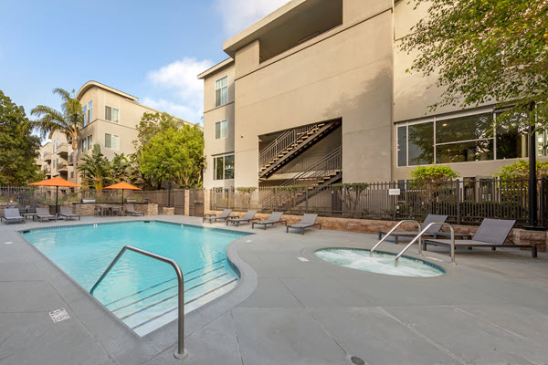 Outdoor swimming pool area with lounge seating.