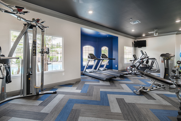 Fitness center with cardio and strength training equipment.
