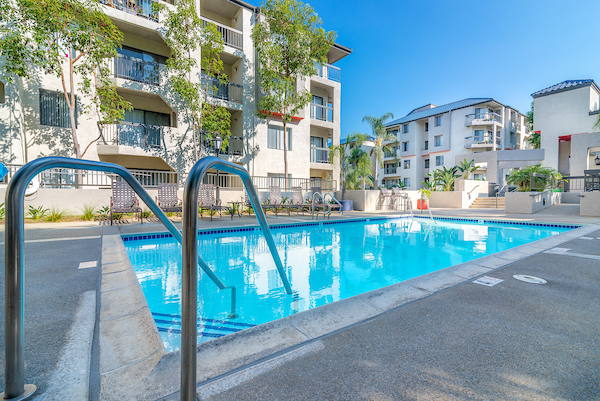 Outdoor swimming pool area with lounge seating.