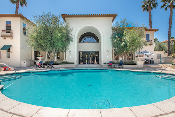 Outdoor swimming pool area surrounded by lounge chairs.