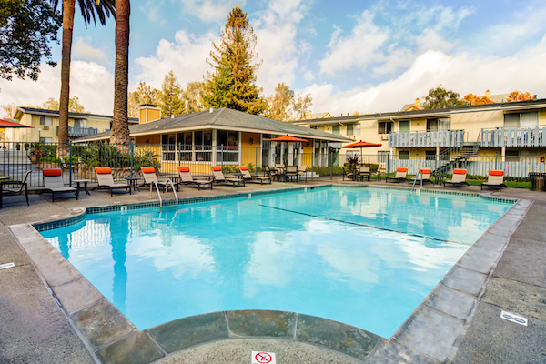 Outdoor swimming pool area with lounge seating.