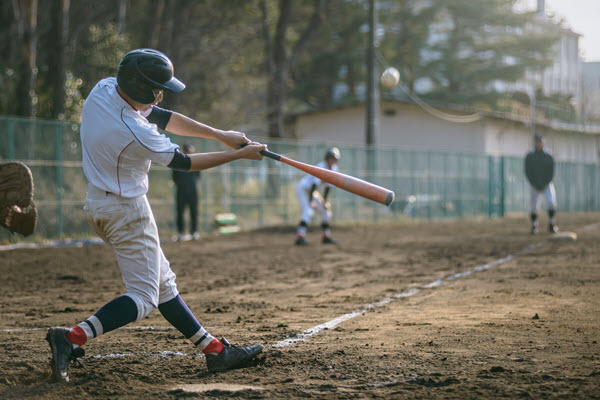 Kid swinging bat at baseball game.