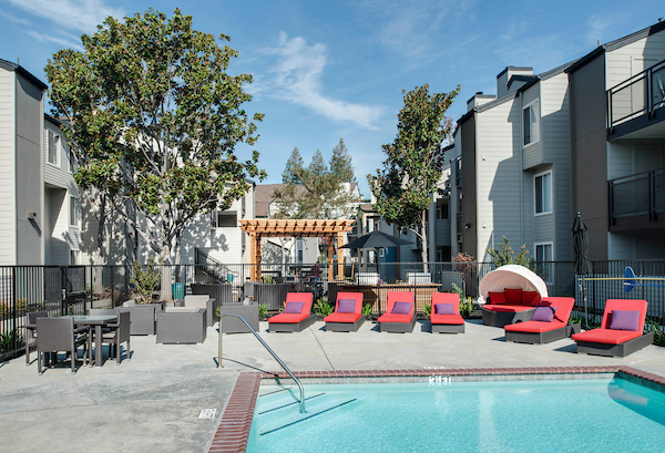 Outdoor swimming pool area with lounge seating.